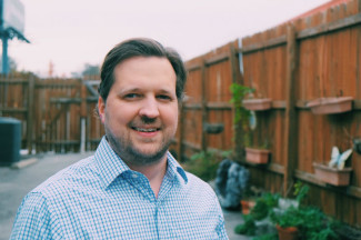 Dr. John Olsen brown hair mustache and beard wearing blue shirt - Nashville TN - East End Chiro