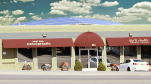 Outside view of office with brown awning and white car parked out front
